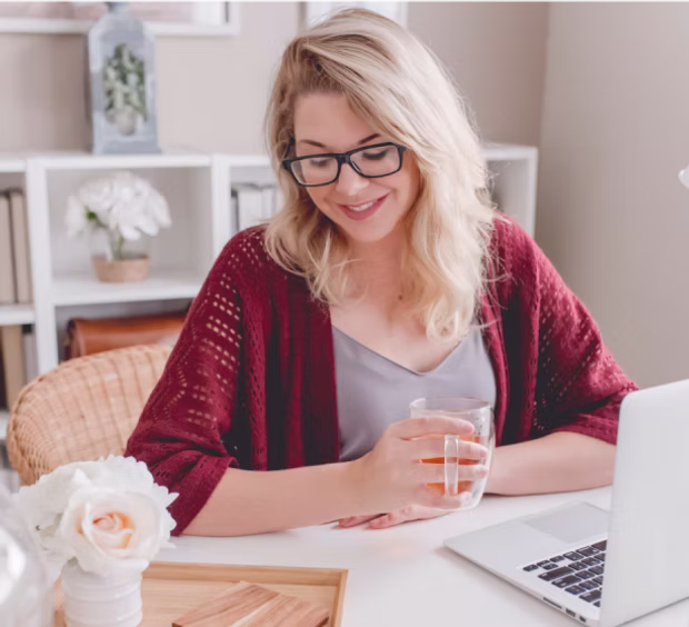 Woman smiling at a laptop